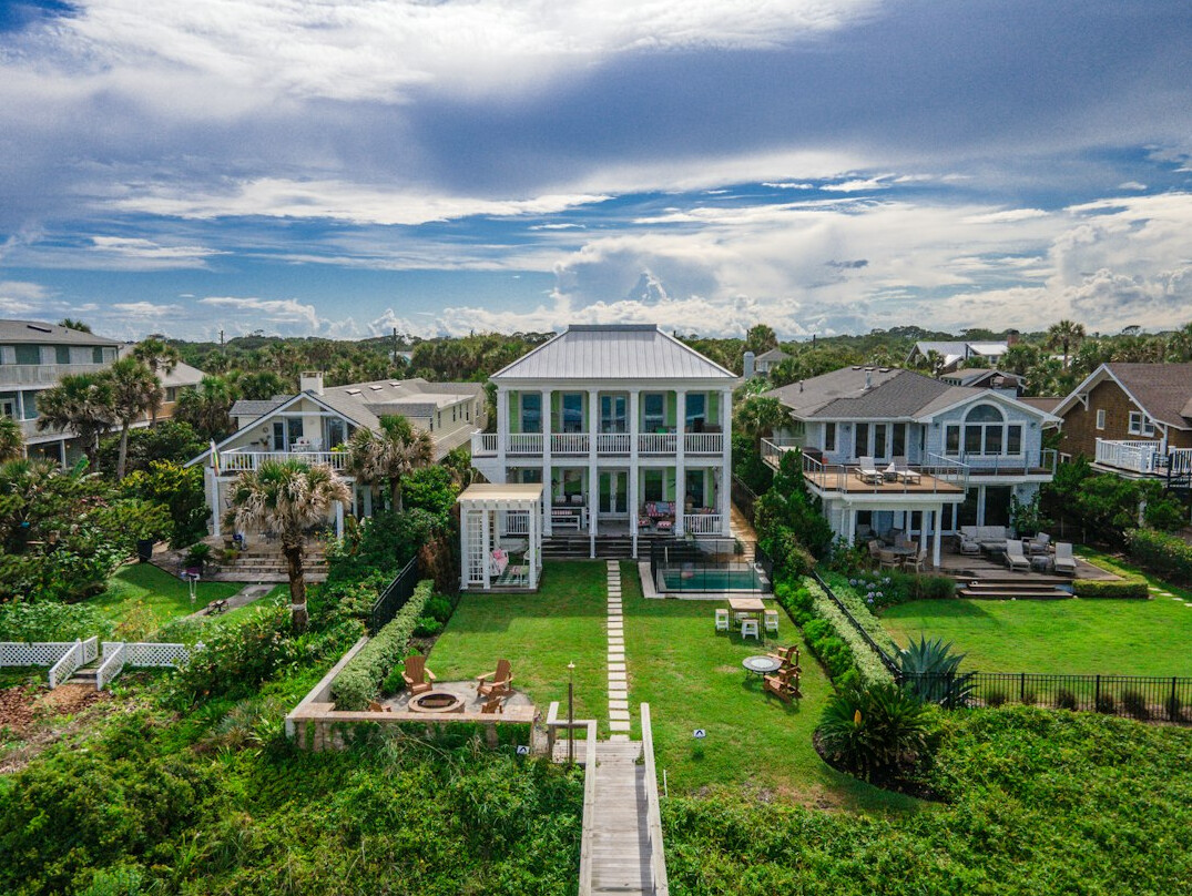 Aerial view of a luxury coastal estate with pool and gardens