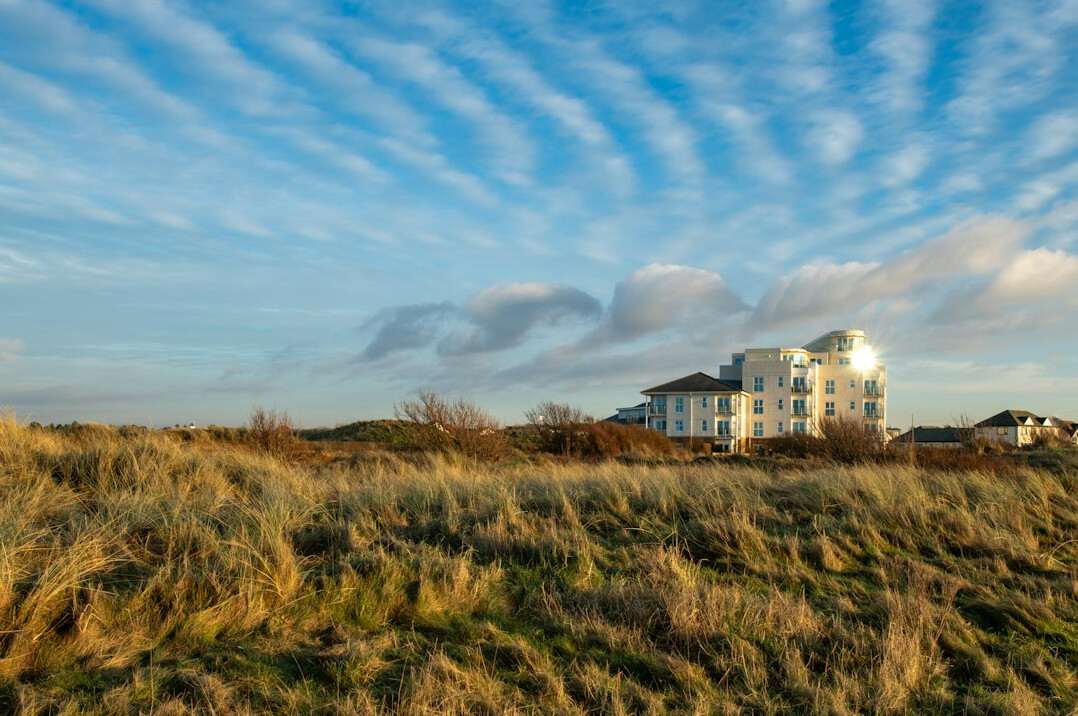 Contemporary beach house surrounded by dunes and coastal grass